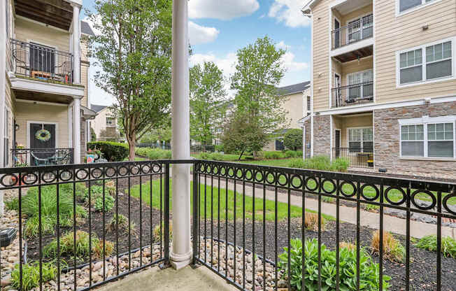 A black metal fence with a gate stands in front of a building.