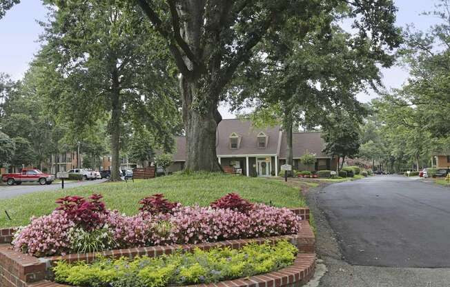 a flower garden in front of a house