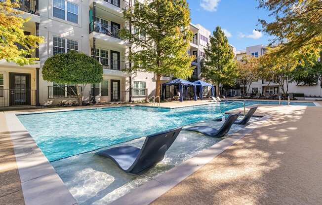 a swimming pool in front of an apartment building