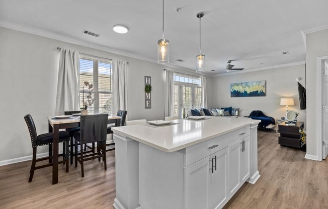 an open concept kitchen and living room with an island and a dining table