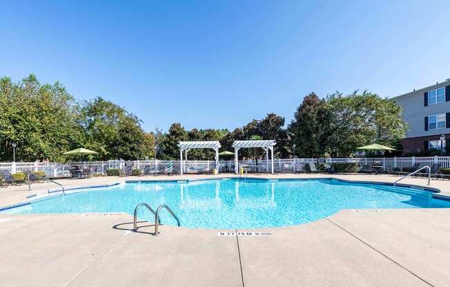 A large outdoor swimming pool surrounded by a fence.