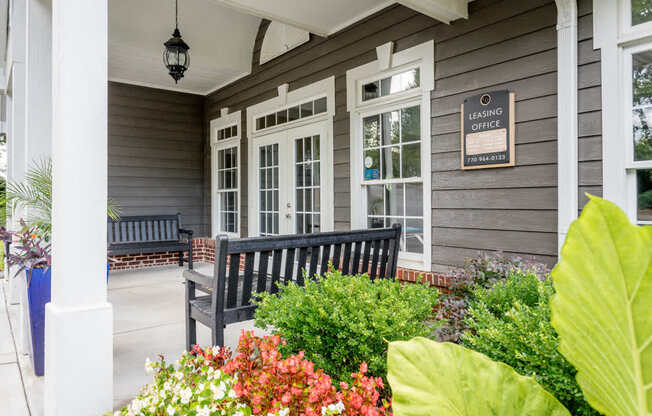 A grey house with a sign that says