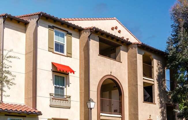 a building with a red roof and a blue sky