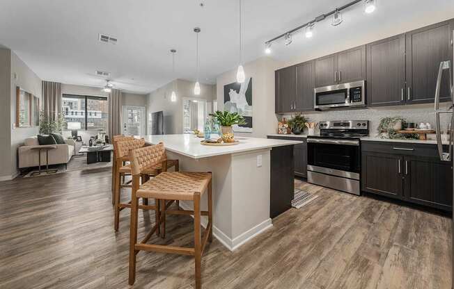 A modern kitchen with wooden floors and a large island.