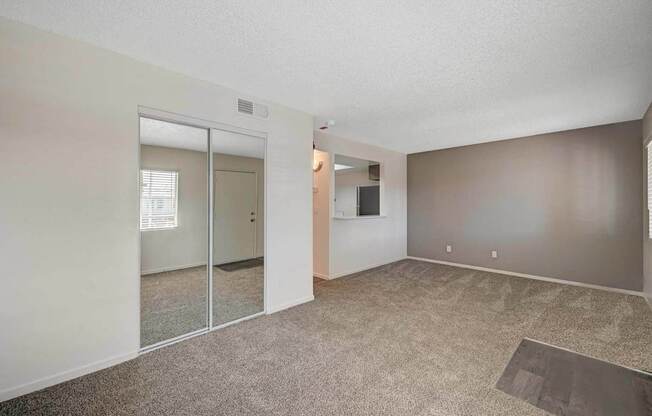 A room with a carpeted floor and a sliding glass door.