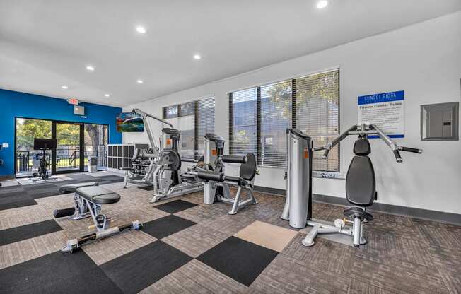 a gym with weights and cardio equipment at the preserve at greatstone  at Sunset Ridge, San Antonio, TX