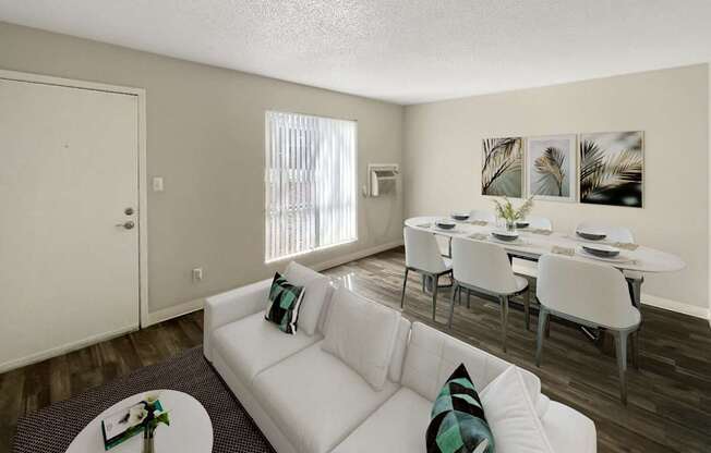 A living room with a white couch and a coffee table.