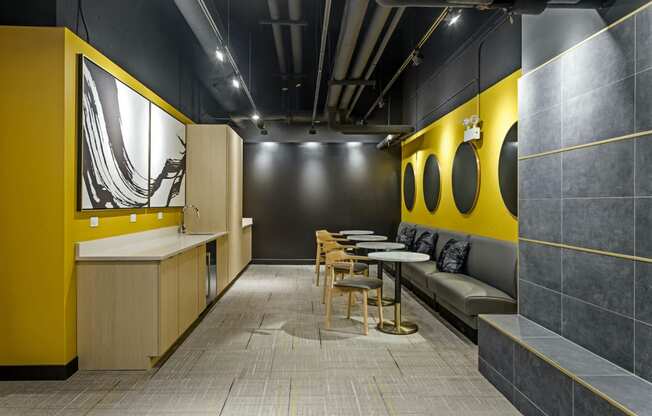 a dining room with tables and chairs and a yellow wall