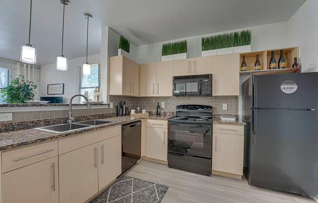 Kitchen With Black Appliances at Vue Live Oak, Texas, 75204