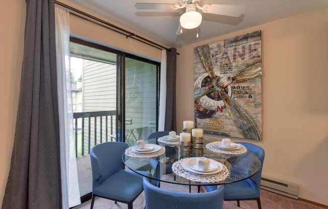 Dining Area with View of Private Patio, Blue Chairs, Ceiling Fan/Light