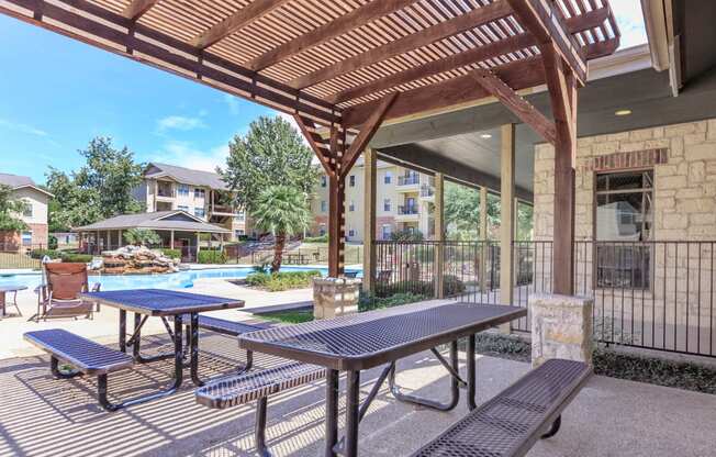 our apartments have a patio with picnic tables and a pool