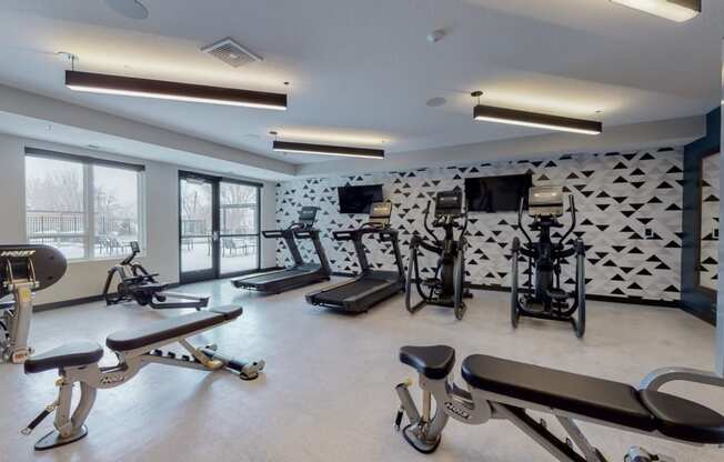 a fitness center with treadmills and other exercise equipment