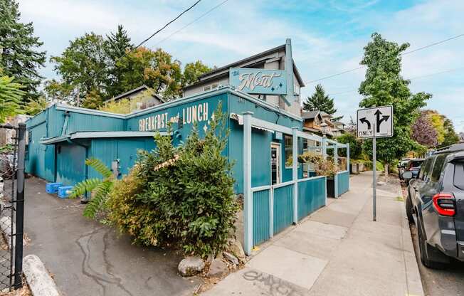A blue building with a sign that says