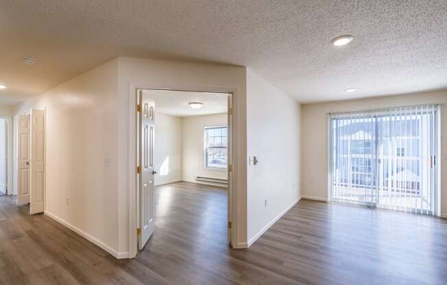 the living room and dining room of an empty apartment. Fargo, ND Stonebridge Apartments