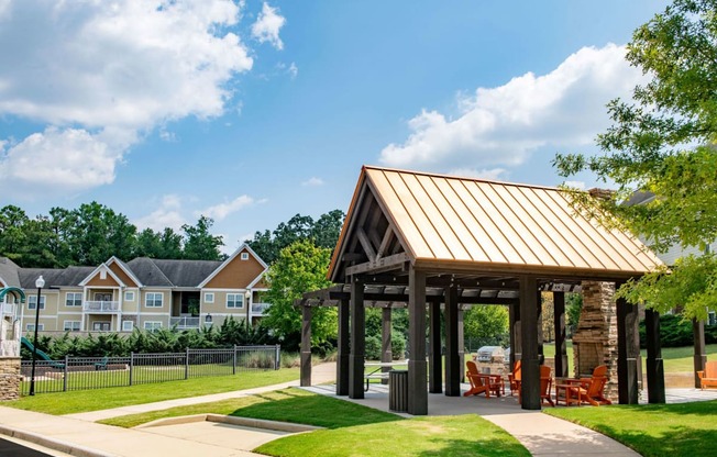 a pavilion with a lawn and trees in the background at Ashby at Ross Bridge, Hoover, AL