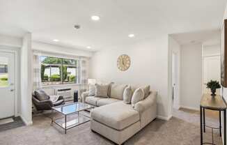 a spacious living room with a couch and a coffee table