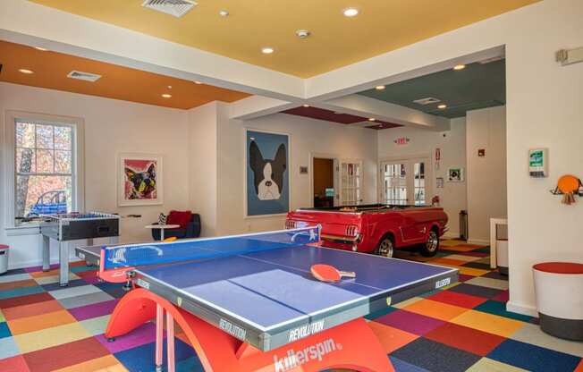 a game room with a ping pong table and a red truck at Residences at Stevens Pond, Saugus, 01906