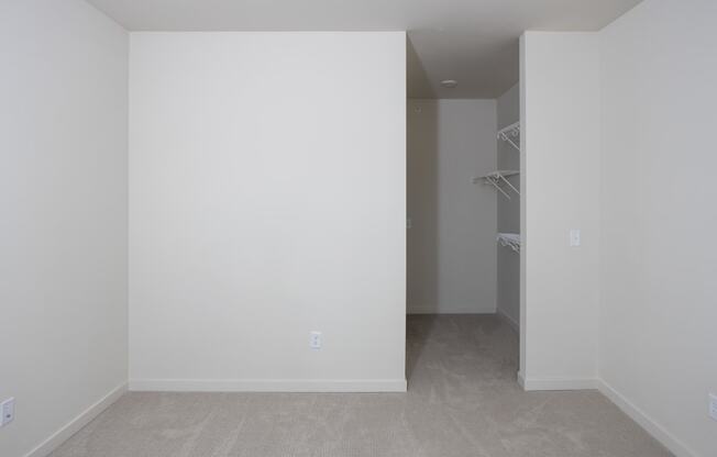 an empty room with white walls and a closet at Riverhouse Apartments, North Dakota