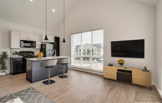 a kitchen and living room with a large window and a view of a house