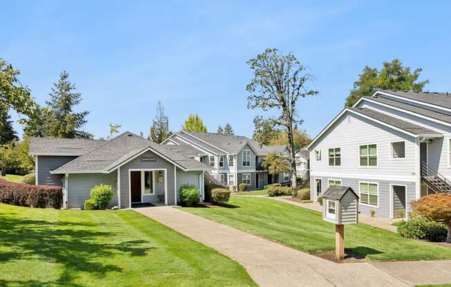 A row of houses with a clear blue sky above them.