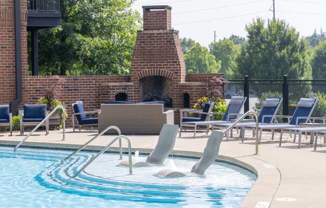 a pool with a brick fireplace in the background