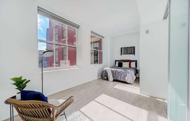 a room with a bed and a chair and a window