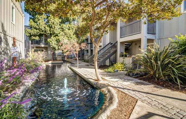 A small fountain in the middle of a garden.