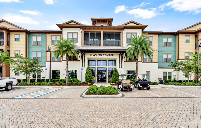 a large building with palm trees in front of it