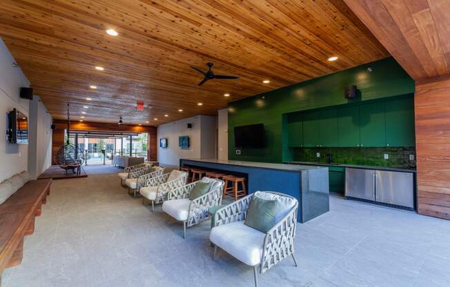 Studios in Old East Dallas, TX - 4600 Ross - Lounge with a Community Kitchen, Various Cozy Seating Options, and Multiple TVs