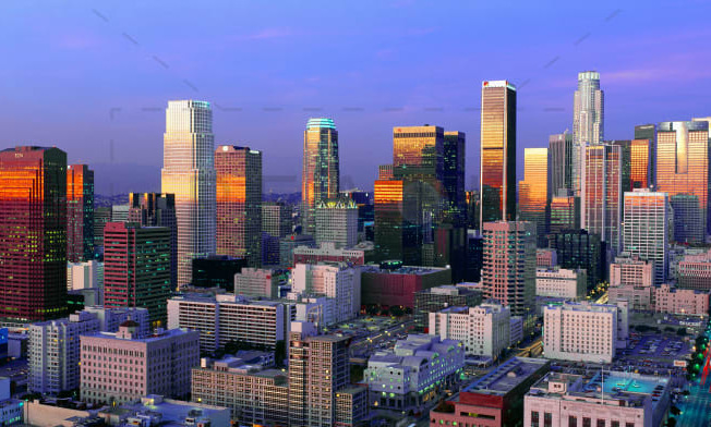 a sunset view of a city skyline with skyscrapers