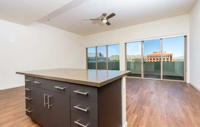 kitchen island and  livingroom with wood style floor and large windows