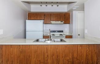 a kitchen with a sink and a refrigerator