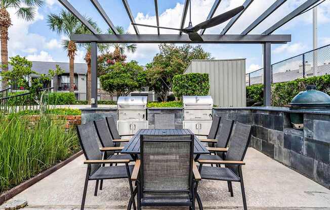 A patio with a table and chairs under a roof.