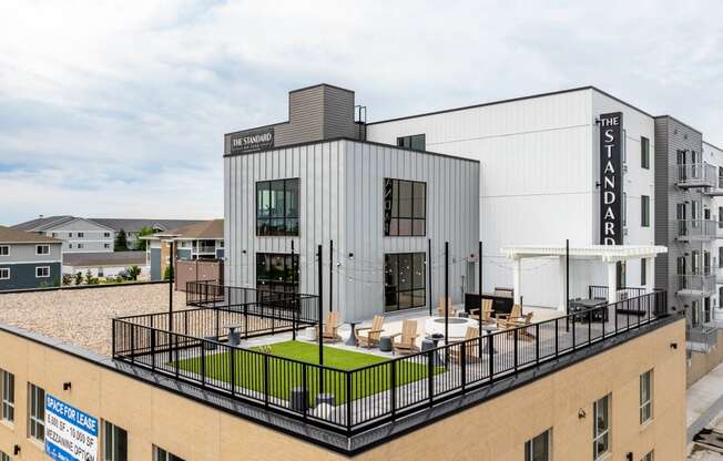 a rendering of a building with a rooftop terrace at The Standard on 32nd, West Fargo, ND