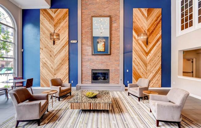 a living room with blue walls and a brick fireplace