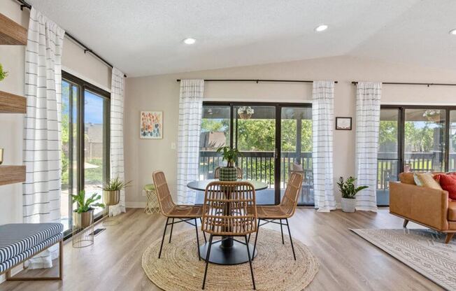 a dining room with a table and chairs and a balcony