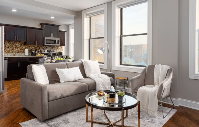 a living room with a couch and a chair and a table