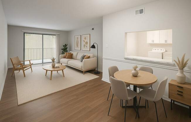 A living room with a white couch, wooden chairs, and a round table.