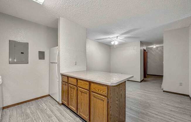 an empty kitchen with a counter top and a refrigerator at Creekstone Falls, Sioux Falls, SD, 57106