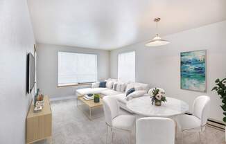 A living room with a white couch and a coffee table.