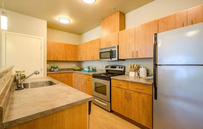 A kitchen with wooden cabinets and a refrigerator.