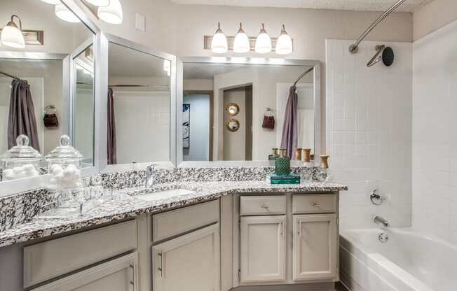 the preserve at ballantyne commons executive bathroom with granite counter tops and a tub