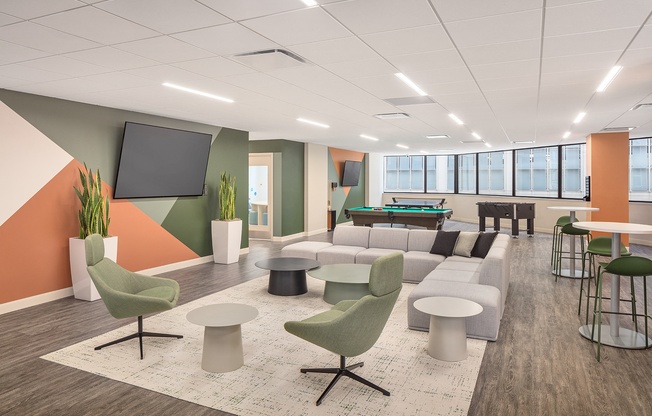 a lounge area with couches and chairs and a pool table