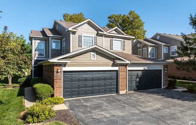 A large house with a grey garage door.