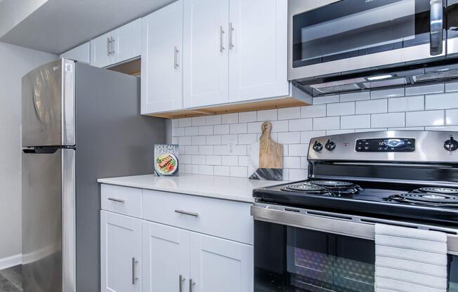 a stove top oven sitting inside of a kitchen