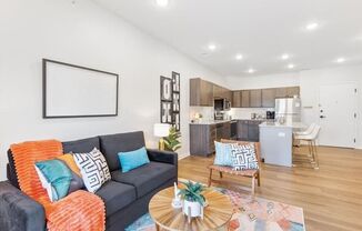 A living room with a grey couch and a coffee table.