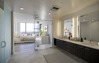 a bathroom with a large mirror and a sink and a shower