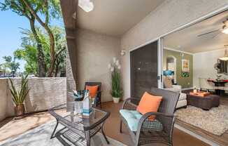 A patio with a chair and a table.