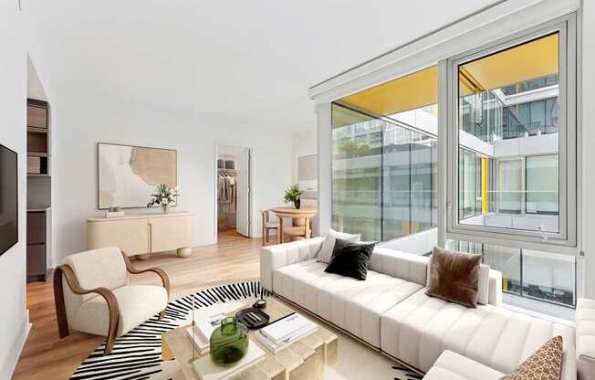 A living room with a white couch and a coffee table.