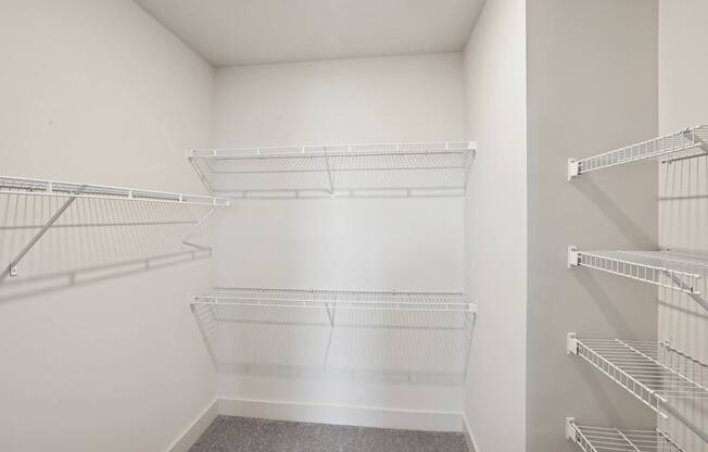 Empty white shelves in a room.